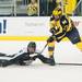 Spartans right defensemen John Draeger  reaches for the puck after falling as he fights Wolverines left wing Alex Guptill for it third period.
Courtney Sacco I AnnAorbor.com 
